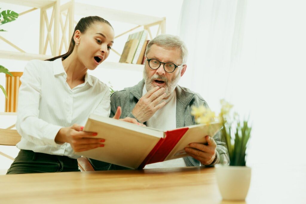 An elderly man being treated by a woman speech therapist at home)