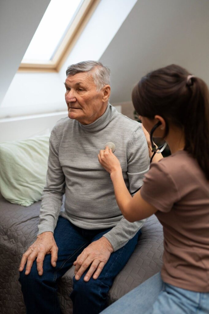 Elderly person being diagnosed at home by a female speech therapist