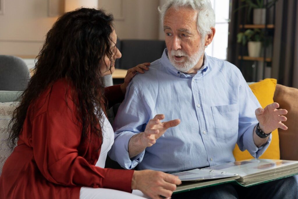 A speech therapist training an elder how to read