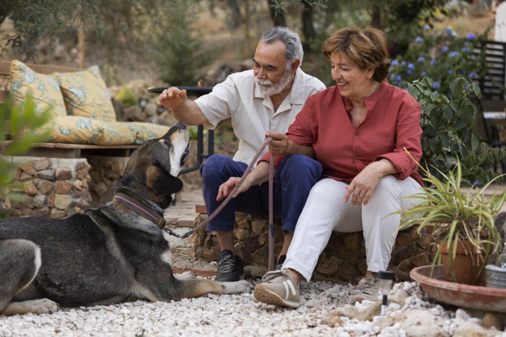 Seniors spending a quality time outside with a dog in their retirement village