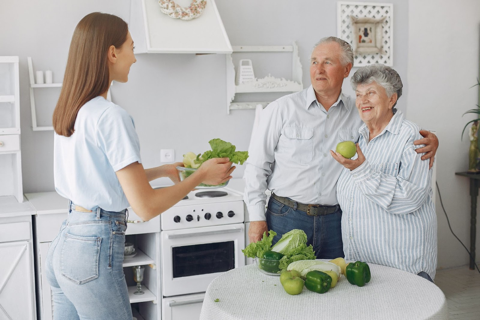 Dietitian offering fresh produce to elderly clients at home as part of personalised support in home care for dietetics