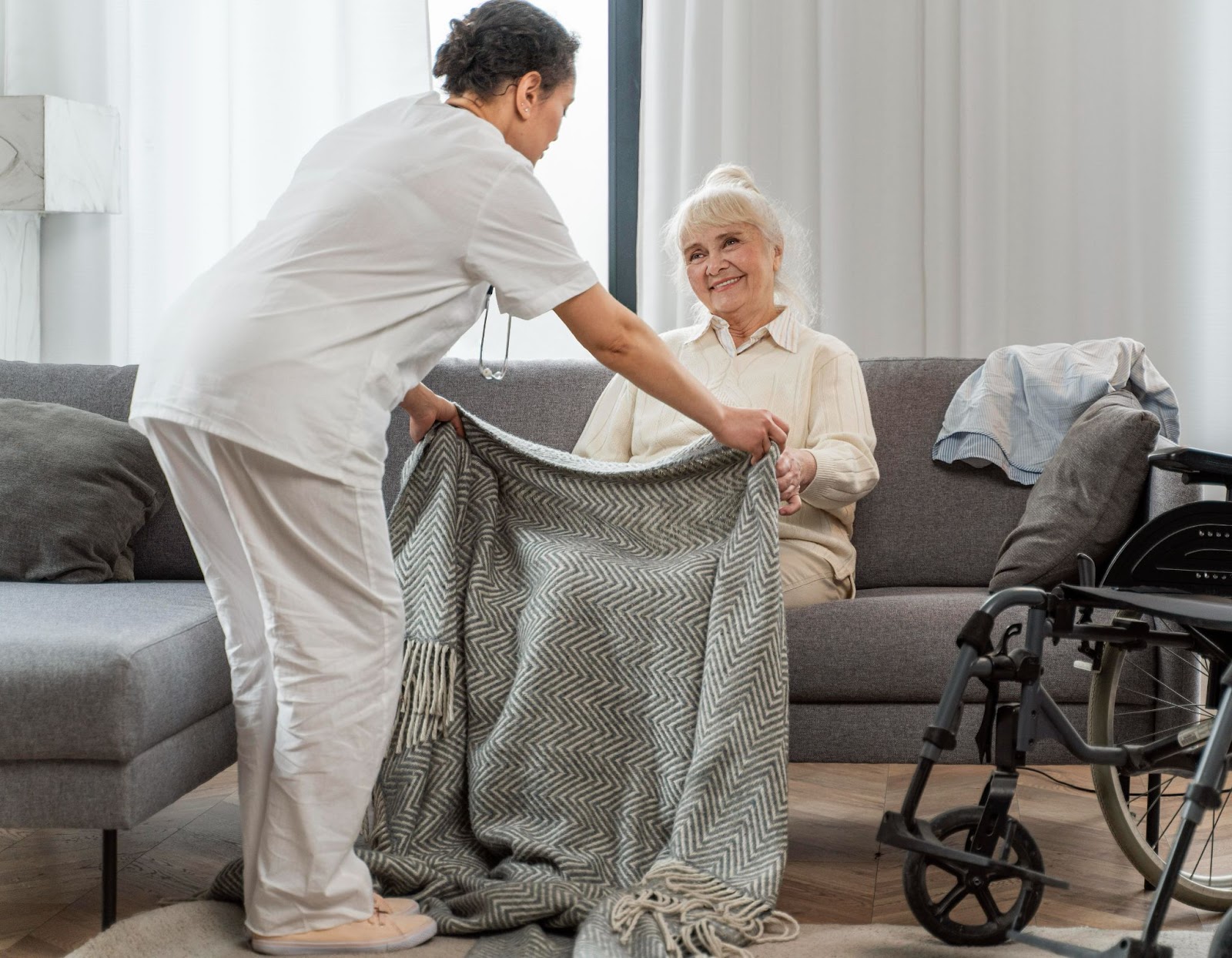 Caregiver assisting elderly woman with a personalised home care plan by providing comfort at home