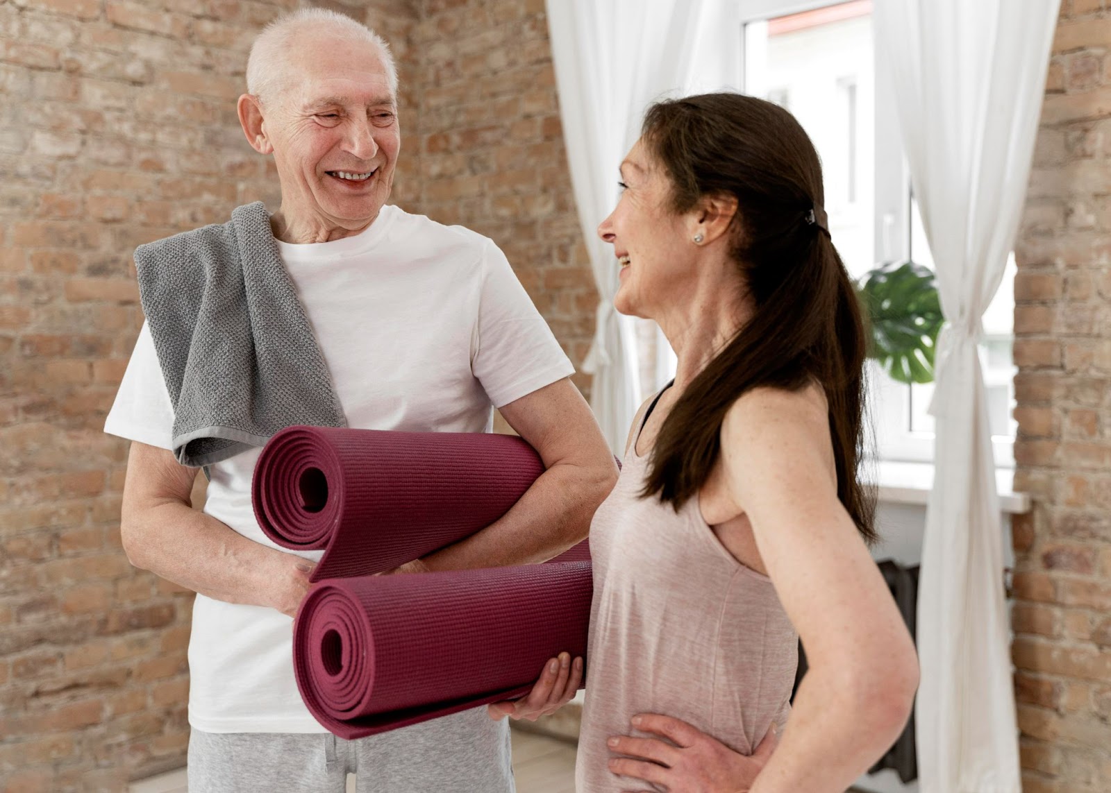 Senior couple preparing for physiotherapy exercises at home to maintain independence and physical well-being