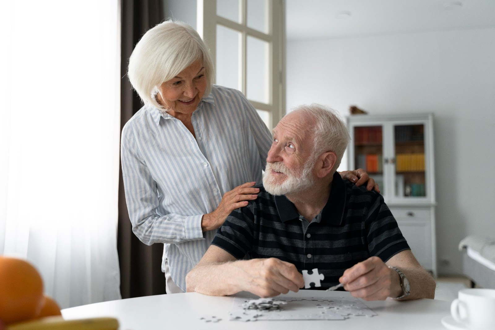 Senior man completing a puzzle as part of cognitive therapy to delay cognitive decline in aged care